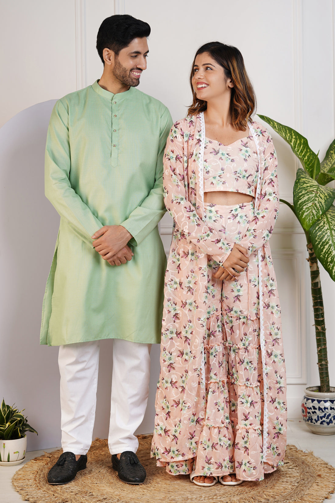 Charming Peach Floral Crop Top with Comfy Pants and Shrug, Paired with a Green Kurta and White Pyjama Matching Couple Set