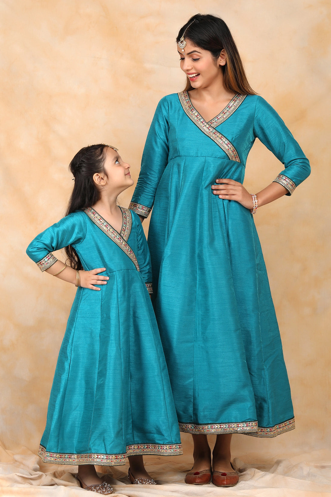 Exquisite Peacock Blue Ethnic Silk Gown Set for Mom and Daughter – Perfectly Coordinated Twin Outfits